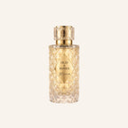 Perfume bottle labeled 'Oud & Roses' on a light beige background