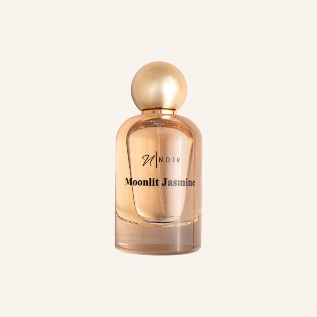 Perfume bottle labeled 'Moonlit Jasmine' on a light beige background