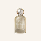 Perfume bottle labeled 'Dewy Blossom' by 'Unoir' on a light beige background