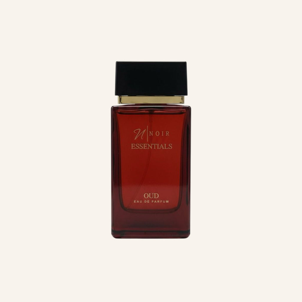 Red perfume bottle with black cap on a white background