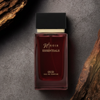 Red perfume bottle labeled 'Noir Essentials' on a dark background with wood elements.