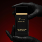 Black perfume bottle labeled noir Essentials Pour Homme' held by a gloved hand against a red background
